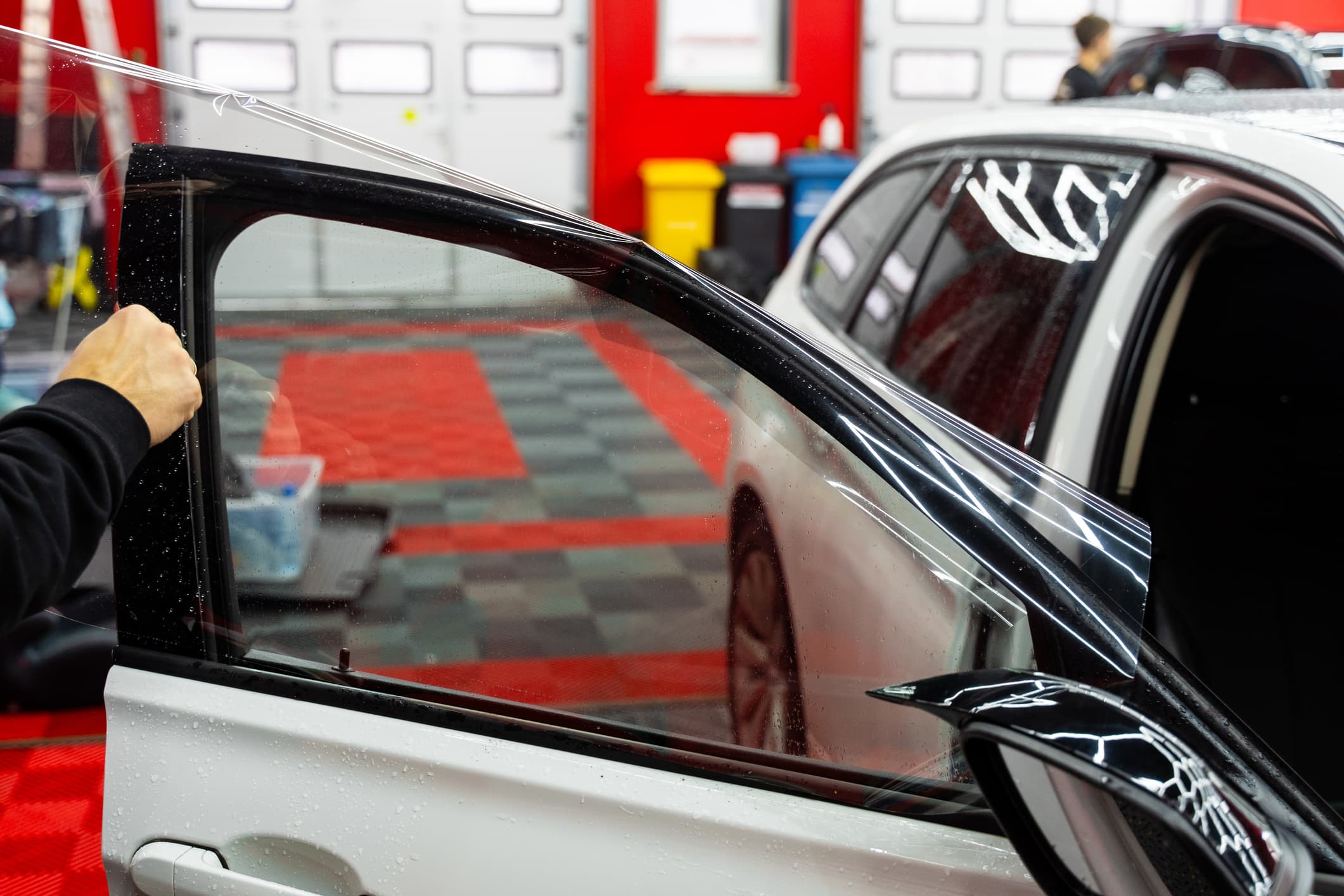 Finished dark window tint on a car, providing UV protection and a sleek, uniform look.